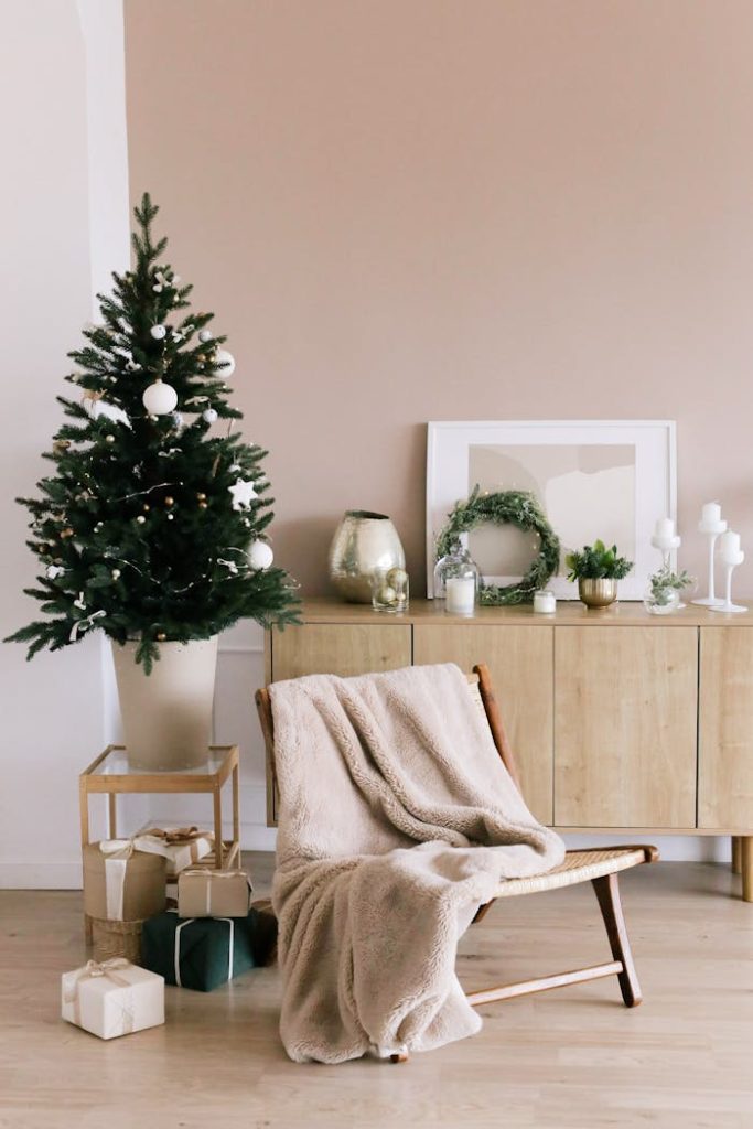 pexels-photo-6204562 Stylish Christmas tree and gifts in a modern minimalist living room setting.